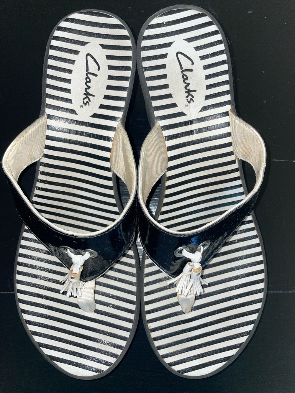 Clarks Women’s Black and White Striped Tassel Thong Sandals. Size 9